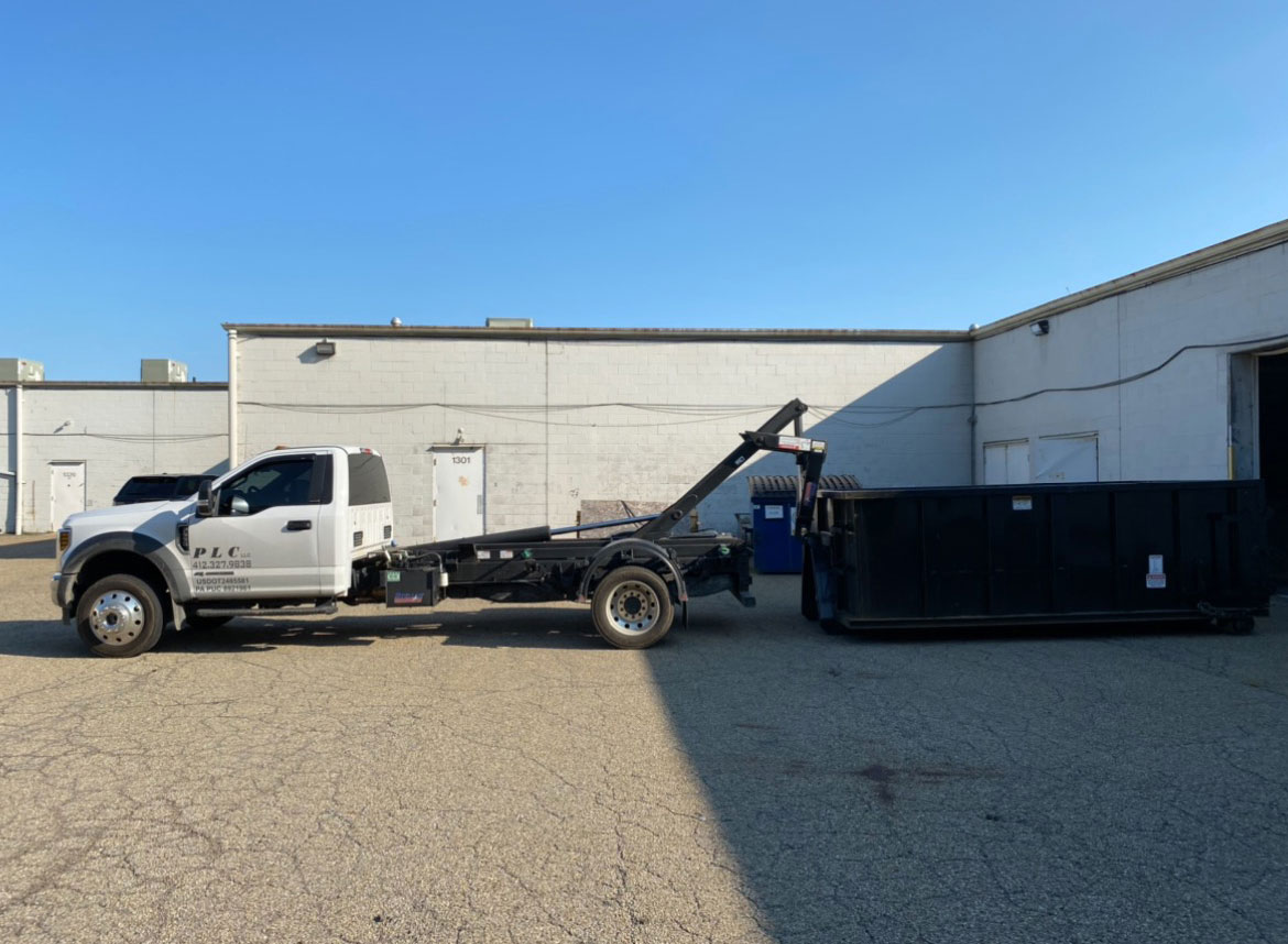 the PLC Hauling truck with a dumpster